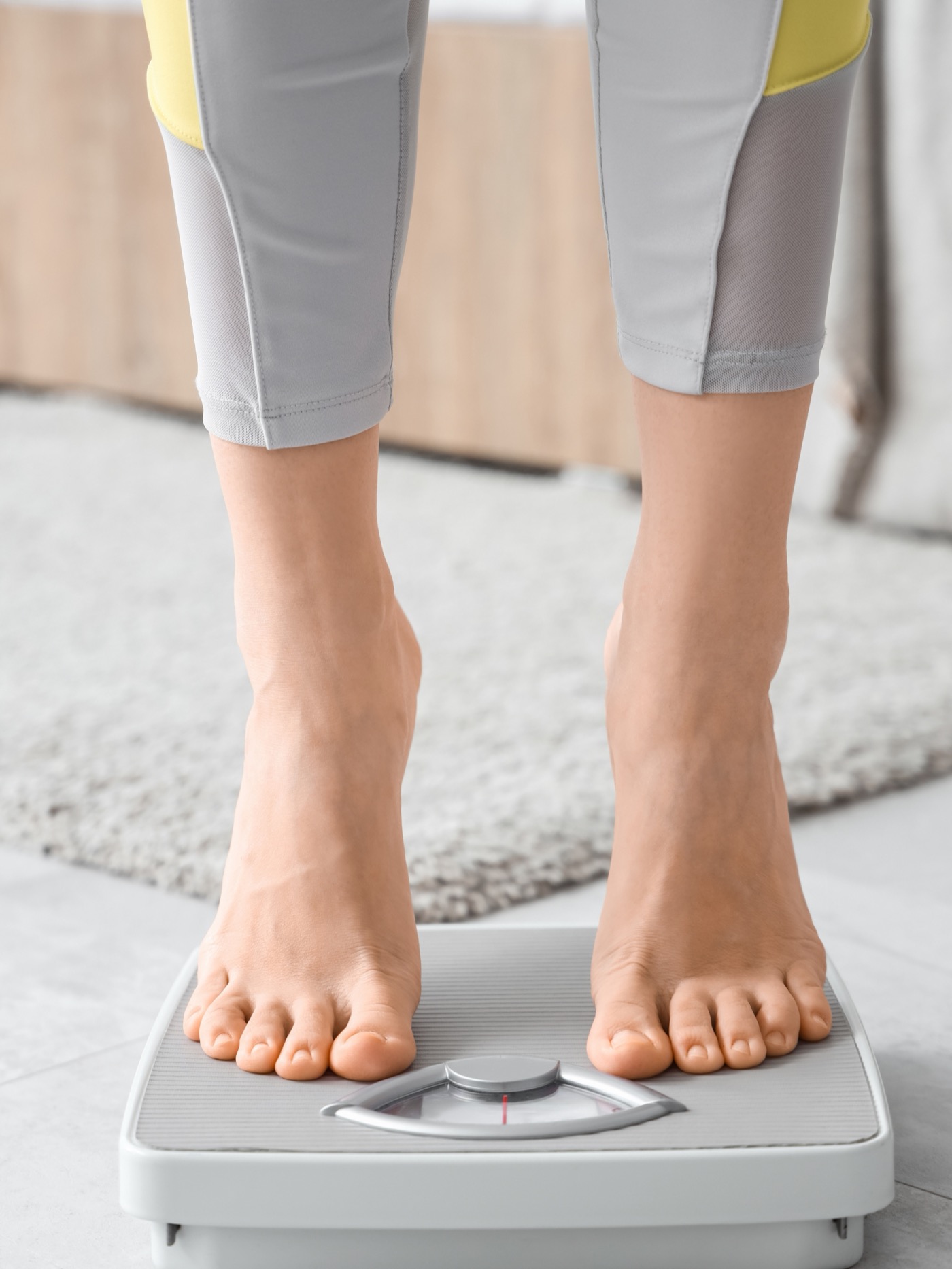 Woman on a scale representing GLP-1 weight management support