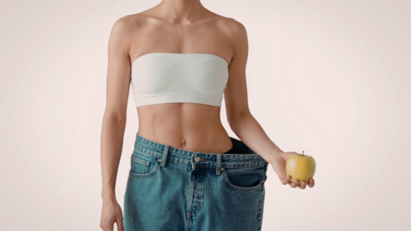 Woman showing weight loss transformation representing GLP-1 and muscle preservation
